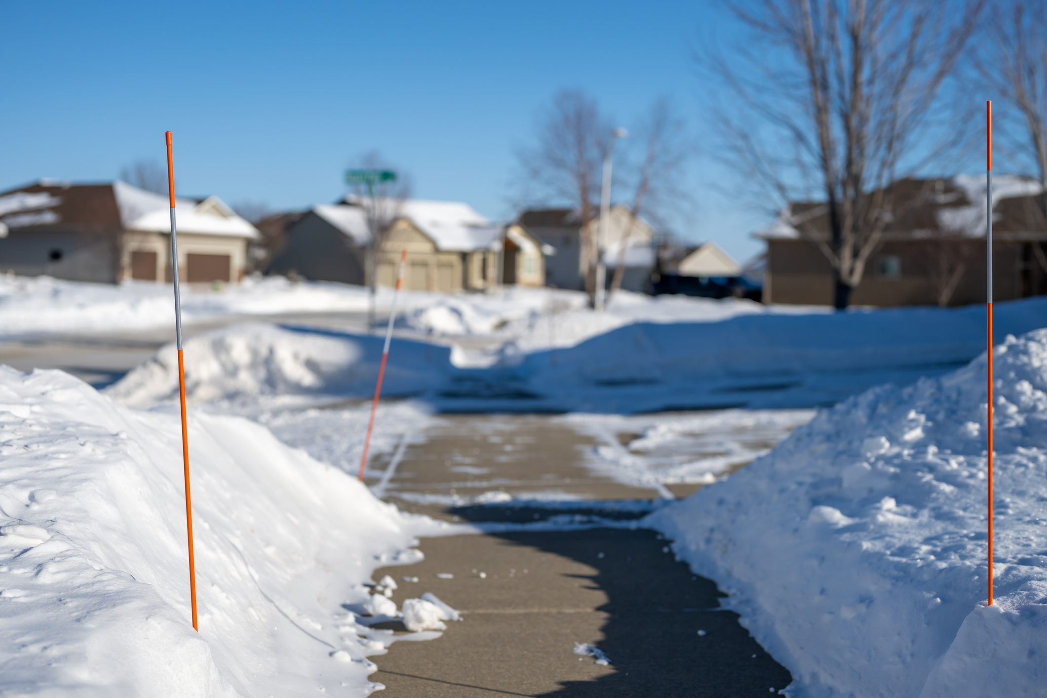 marking lawn with sticks for snow removal