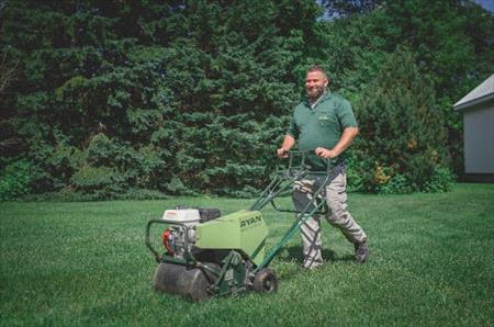 Weed Man technician aerating a lawn